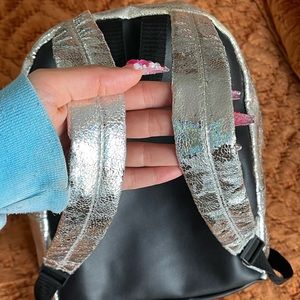 Silver iridescent back pack.